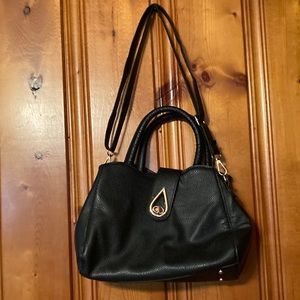 Women’s black NOATD Handbag with rivit shutting and 4 rivits on bottom